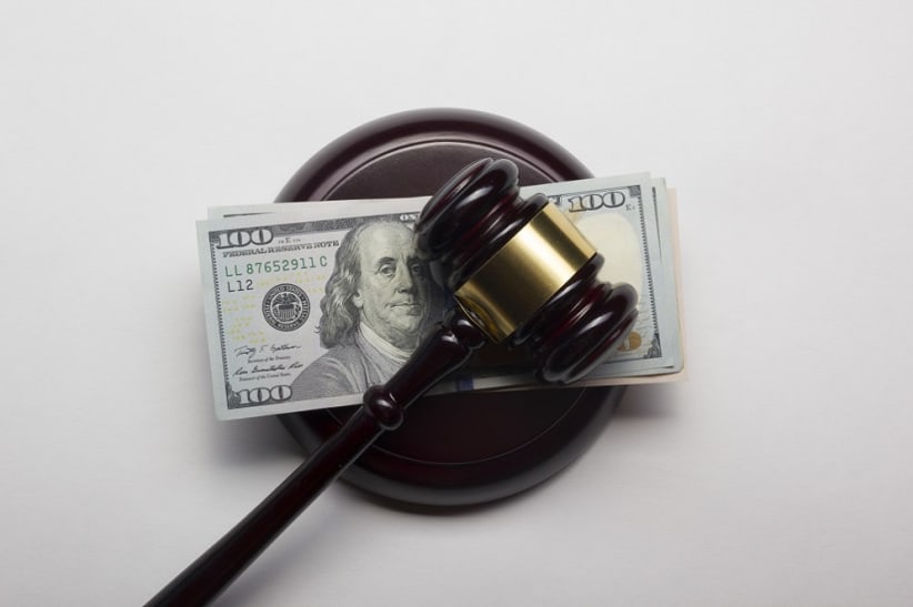 judge gavel on american dollars on white background.