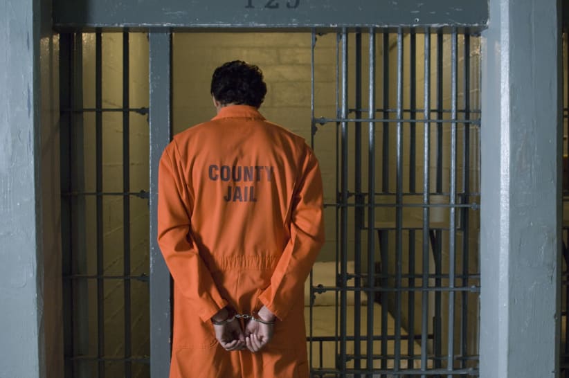 Handcuffed prisoner in jail for misdemeanor or felony