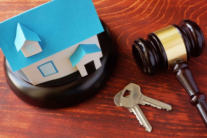Real Estate Law concept.  Model of house and a gavel.