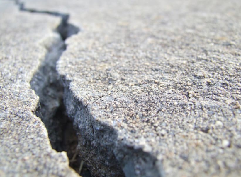 cracked sidewalk or pavement causing danger