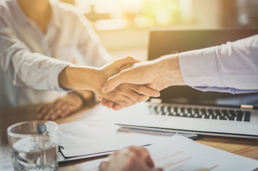 Making a deal for business, shaking hands over a deal