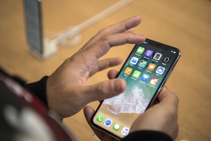 LONDON, ENGLAND - NOVEMBER 03:  A customer views the iPhone X upon its release in the U.K on November 3, 2017 in London, England. The iPhone X is positioned as a high-end, model intended to showcase advanced technologies such as wireless charging, OLED display, dual cameras and a face recognition unlock system.  (Photo by Carl Court/Getty Images)