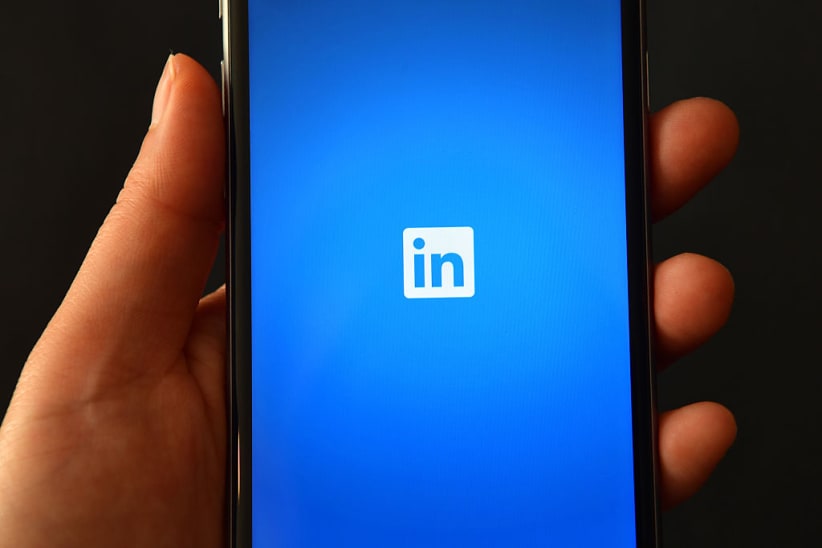 The LinkedIn logo is displayed on an iPhone (Photo by Carl Court/Getty Images)