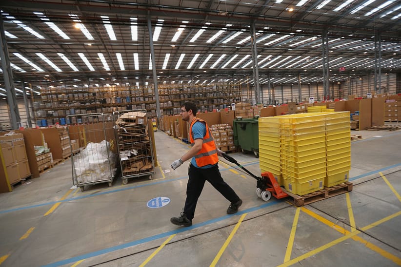 Employees select and dispatch items in an Amazon 'fulfilment centre' warehouse