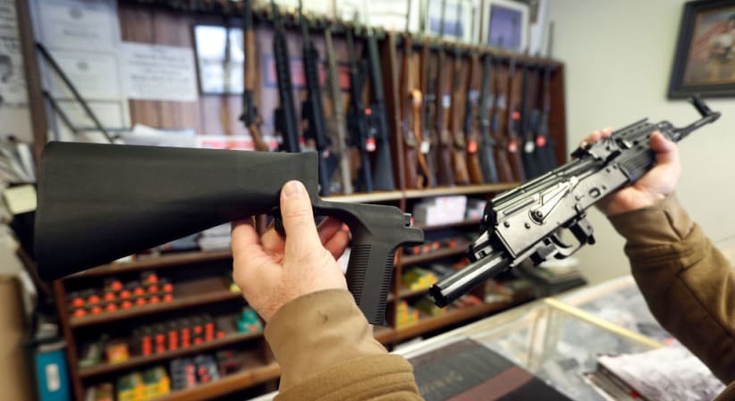 SALT LAKE CITY, UT - OCTOBER 5: A bump stock device, (left) that fits on a semi-automatic rifle to increase the firing speed, making it similar to a fully automatic rifle, is shown next to a AK-47 semi-automatic rifle, (right) at a gun store on October 5, 2017 in Salt Lake City, Utah. (Photo by George Frey/Getty Images)