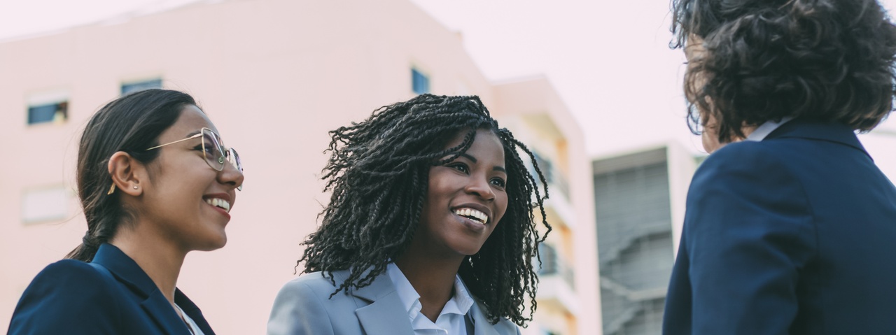 Female attorney meeting clients in a downtown city area.