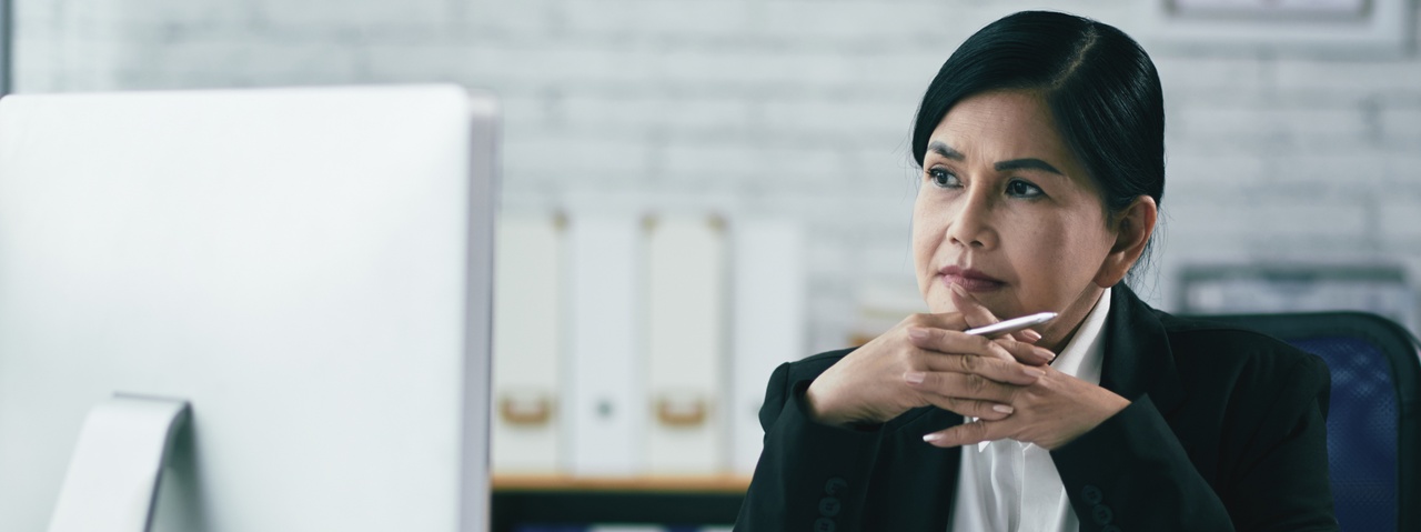 Solo attorney in a modern office looking at a large computer monitor